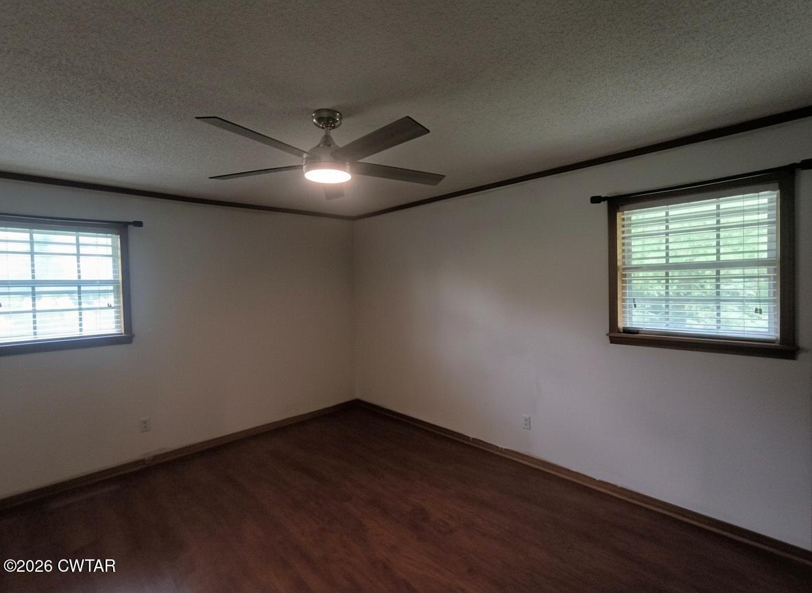 513 Viar Road Dyersburg, TN 38024 - Photo 23 of 37 an empty room with wooden floor and windows