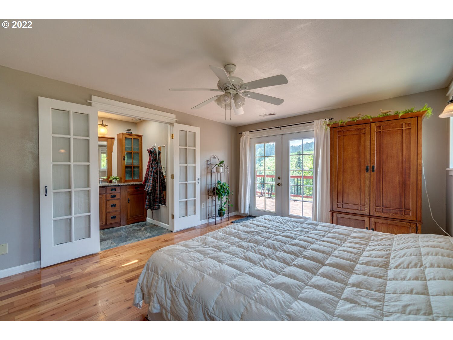 12751 Dupee Valley Road Sheridan, OR 97378 - Photo 16 of 32 a bedroom with a bed and a chandelier