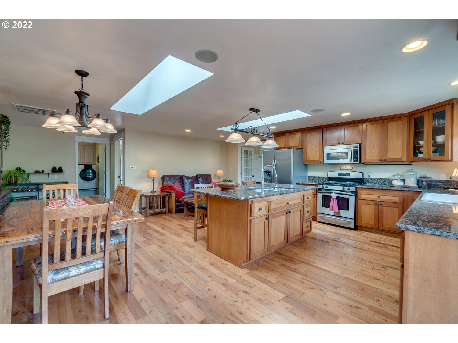 12751 Dupee Valley Road Sheridan, OR 97378 - Photo 7 of 32 a kitchen with stainless steel appliances kitchen island granite countertop a table chairs and a refrigerator