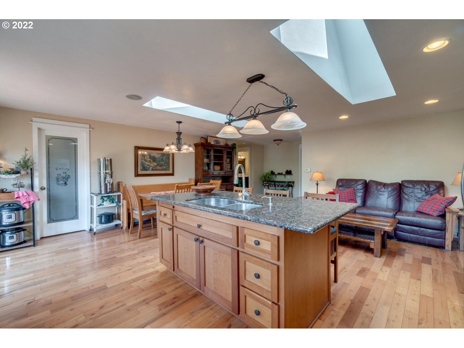 12751 Dupee Valley Road Sheridan, OR 97378 - Photo 8 of 32 a kitchen with stainless steel appliances granite countertop a sink dishwasher and a fireplace with wooden floor