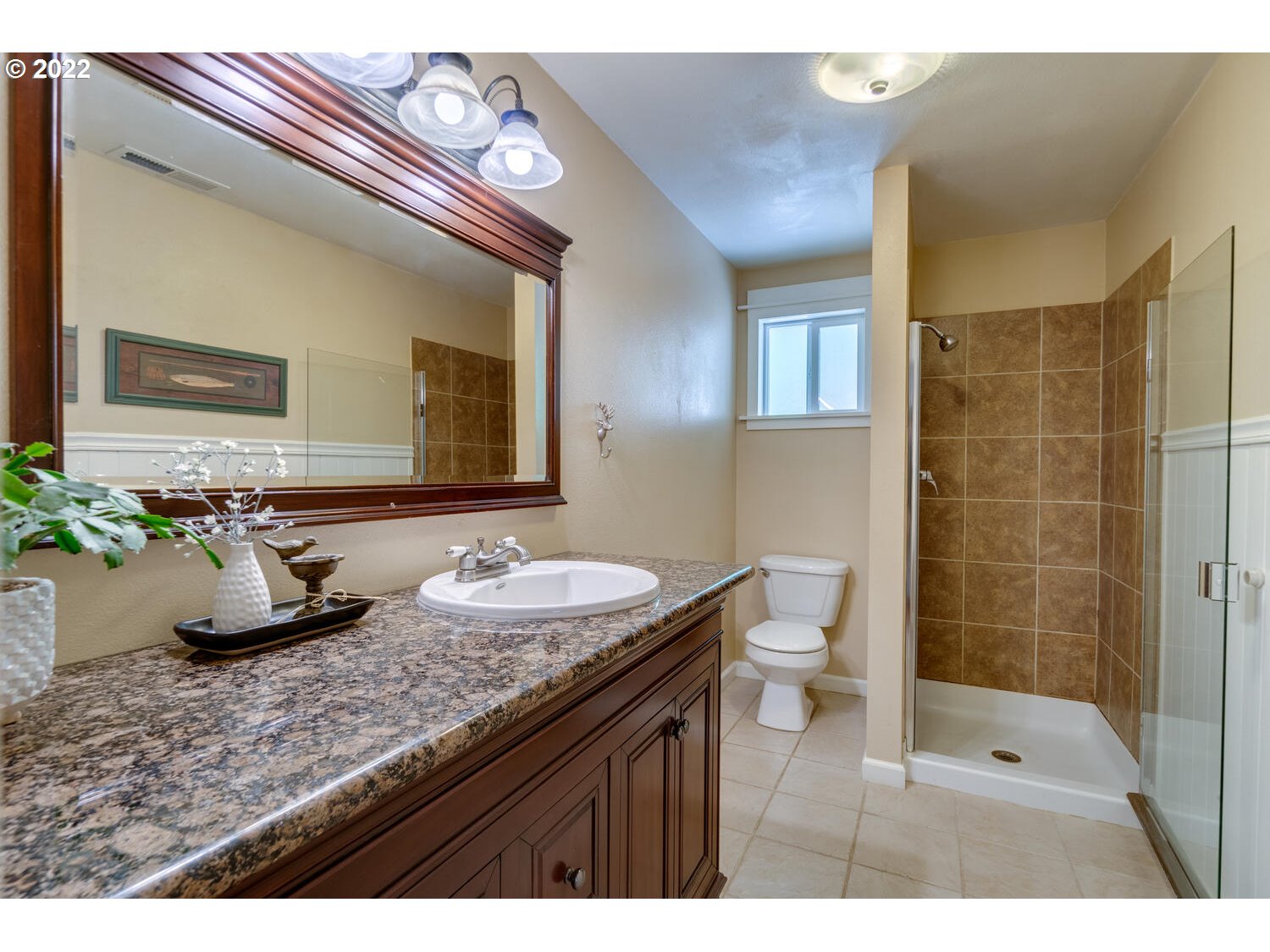 12751 Dupee Valley Road Sheridan, OR 97378 - Photo 9 of 32 a bathroom with a granite countertop sink a toilet a mirror and shower