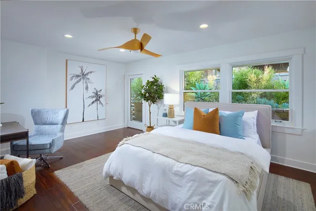 a spacious bedroom with a bed and a large window