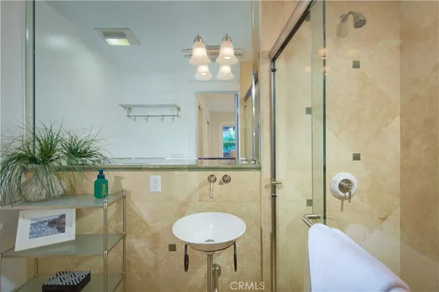 a bathroom with a granite countertop sink a toilet and shower