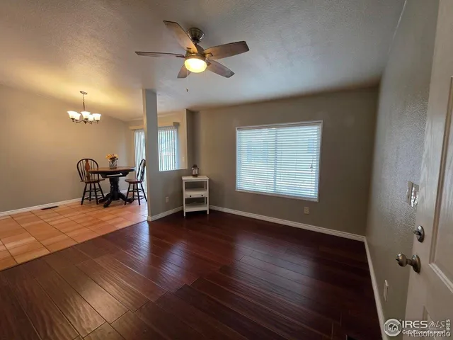 a view of a livingroom with furniture and a window