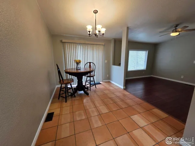 a view of a dining room with furniture and chandelier