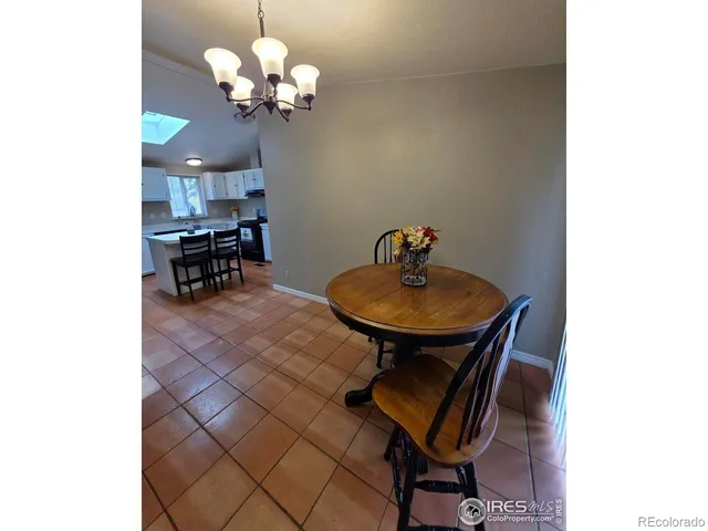 a view of a dining room with a table and chairs