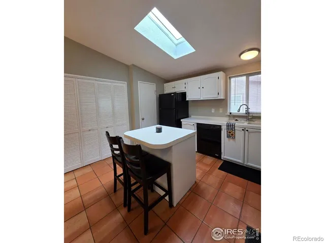 a kitchen with a sink cabinets and stainless steel appliances