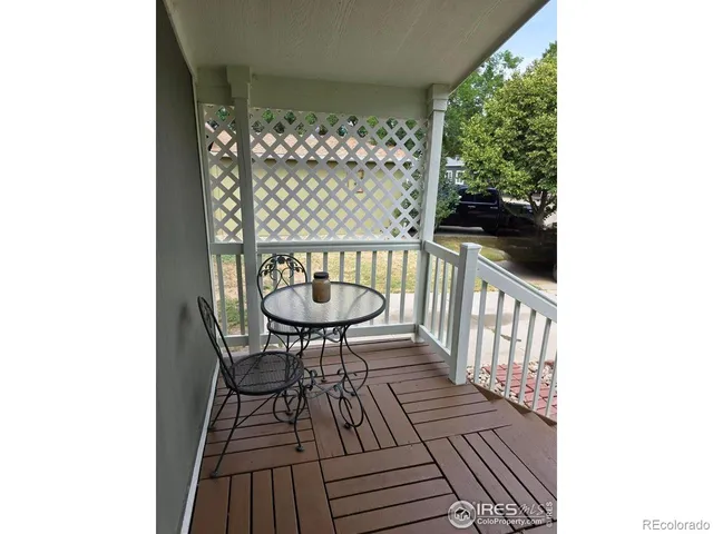 a view of balcony with wooden floor and outdoor seating