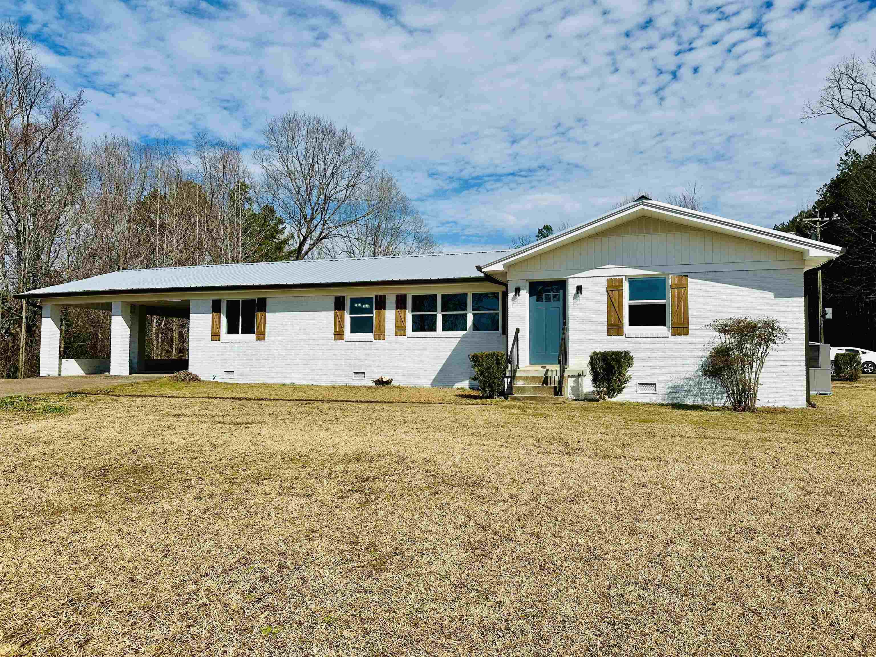2317 Higginbottom Road Selmer, TN 38375 - Photo 1 of 20 View of front of house with entry steps, an attached carport, crawl space, a front yard, and brick siding