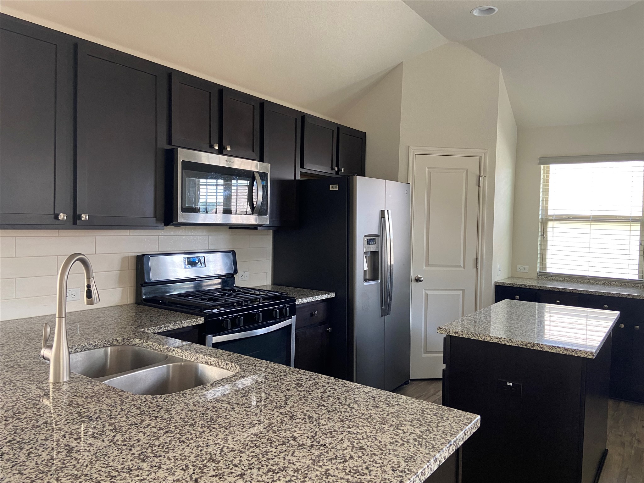 2725 Hopi Path Leander, TX 78641 - Photo 16 of 30 Prepare culinary delights in this modern kitchen, featuring a central island and contemporary appliances.