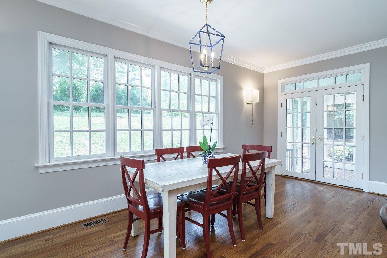3201 Landor Road Raleigh, NC 27609 - Photo 16 of 41 a view of a dining room with furniture window and wooden floor