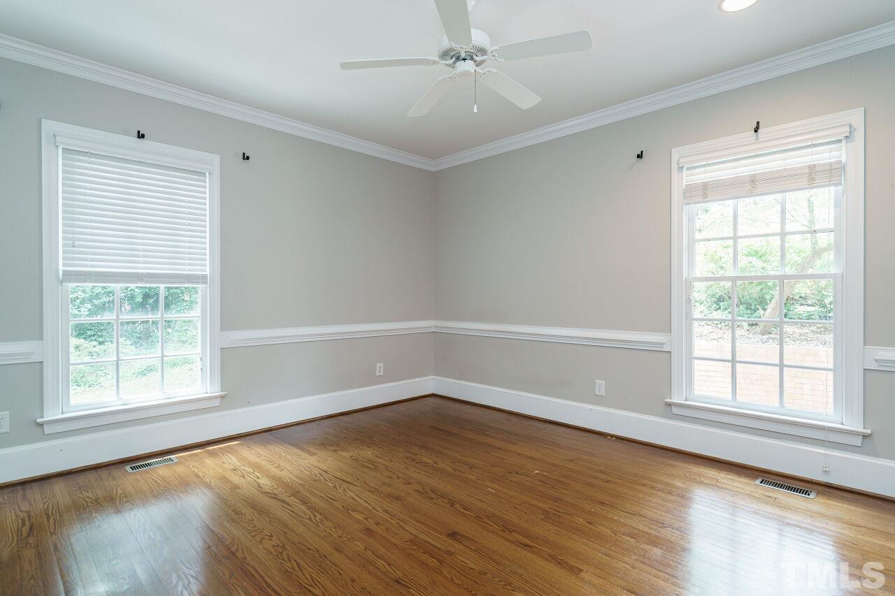 3201 Landor Road Raleigh, NC 27609 - Photo 22 of 41 an empty room with wooden floor and windows