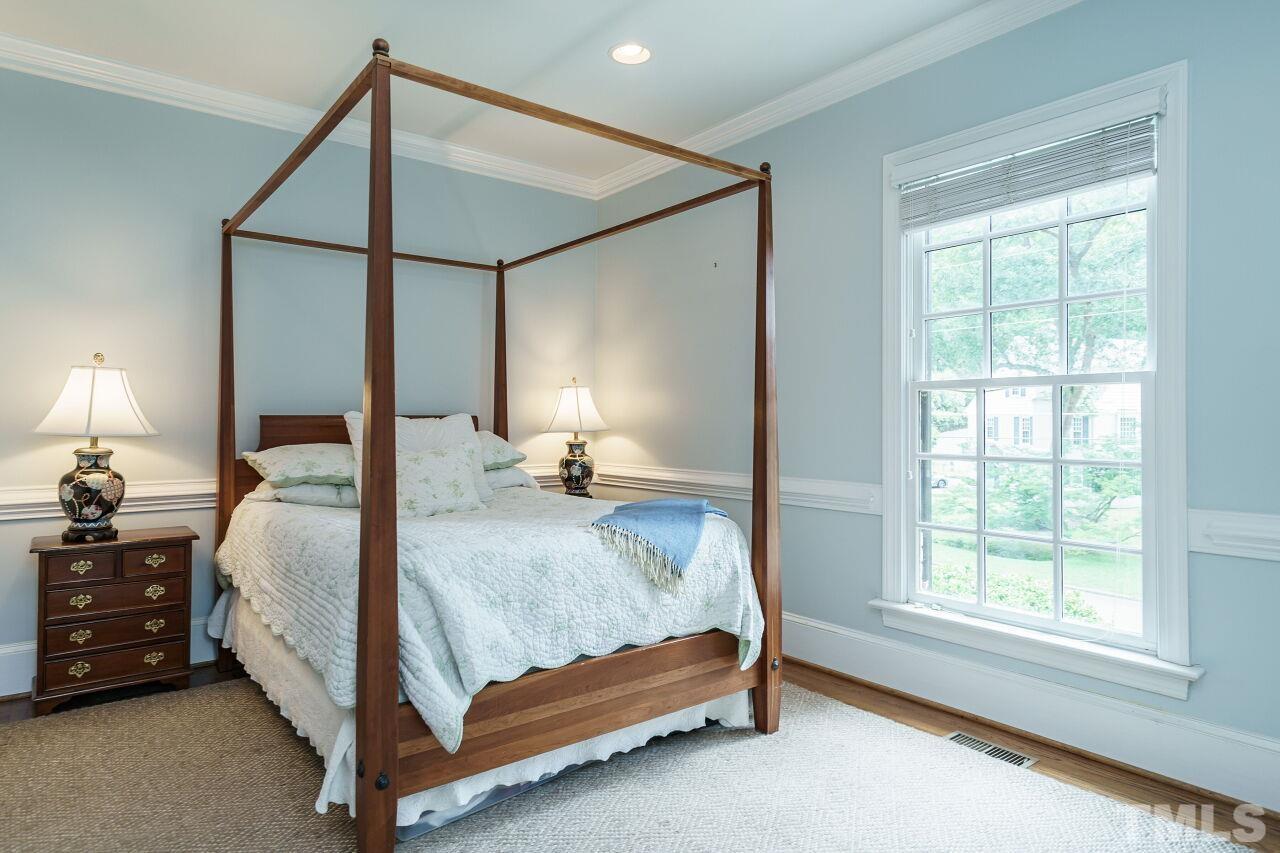 3201 Landor Road Raleigh, NC 27609 - Photo 23 of 41 a bedroom with a bed lamp and a window