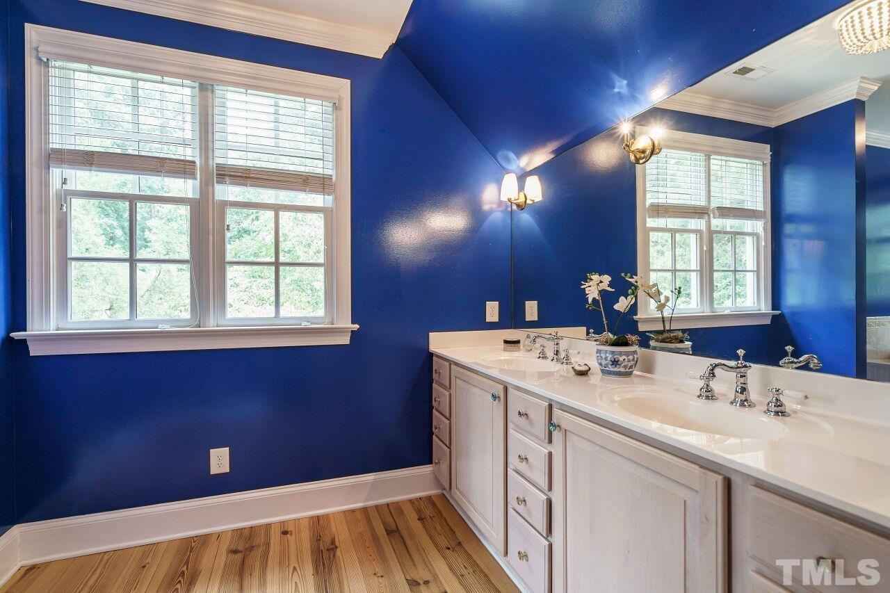 3201 Landor Road Raleigh, NC 27609 - Photo 27 of 41 a bathroom with a sink a vanity and a mirror