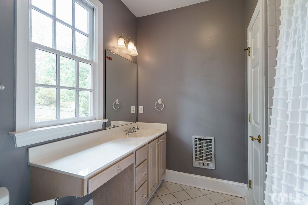 3201 Landor Road Raleigh, NC 27609 - Photo 32 of 41 a bathroom with a sink and a mirror