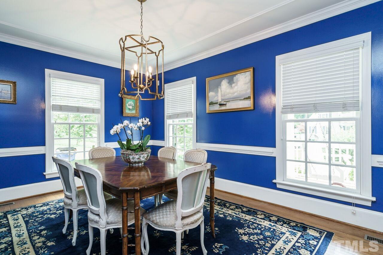 3201 Landor Road Raleigh, NC 27609 - Photo 10 of 41 a dining room with furniture a chandelier and window