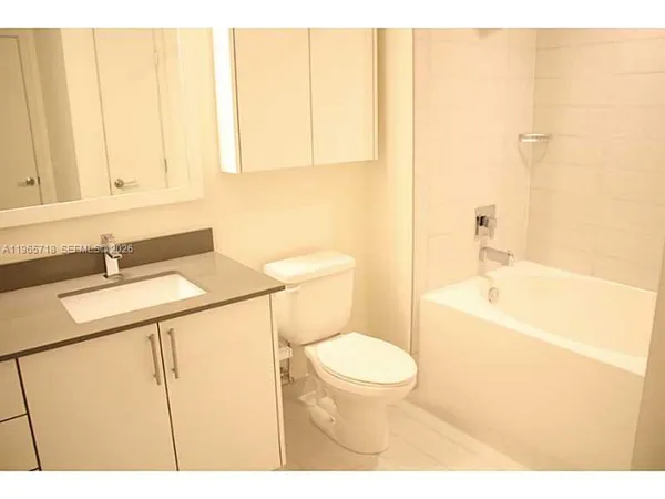 a bathroom with a sink a toilet and tub