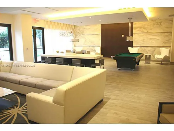 a living room with couches and painting on the wall