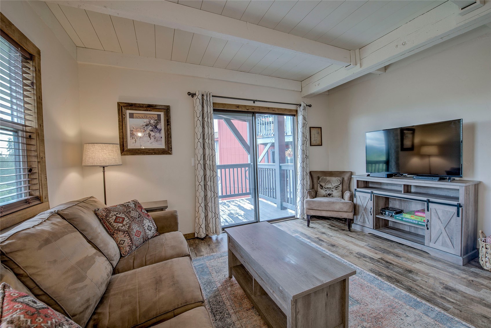 8014 Ryan Gulch Road, Unit B5 Silverthorne, CO 80498 - Photo 1 of 22 Living room with plenty of natural light, beamed ceiling, and luxury vinyl wood-style floors