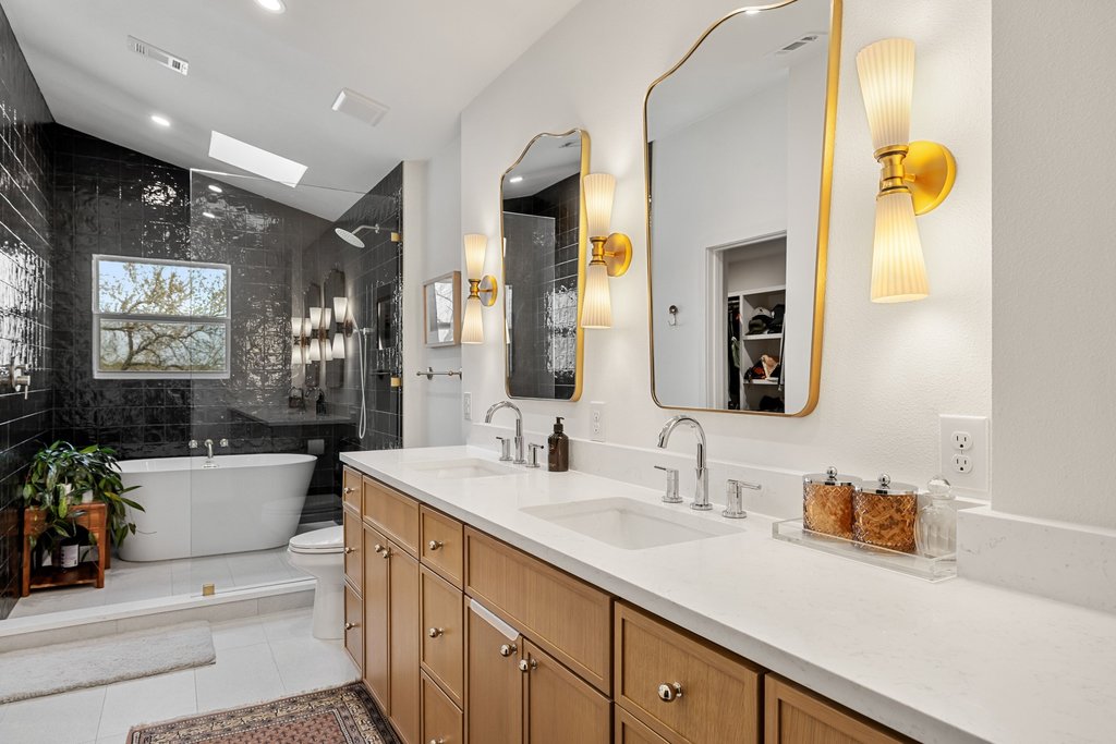 8202 Cache Drive Austin, TX 78749 - Photo 18 of 39 a spacious bathroom with a sink double vanity and a mirror
