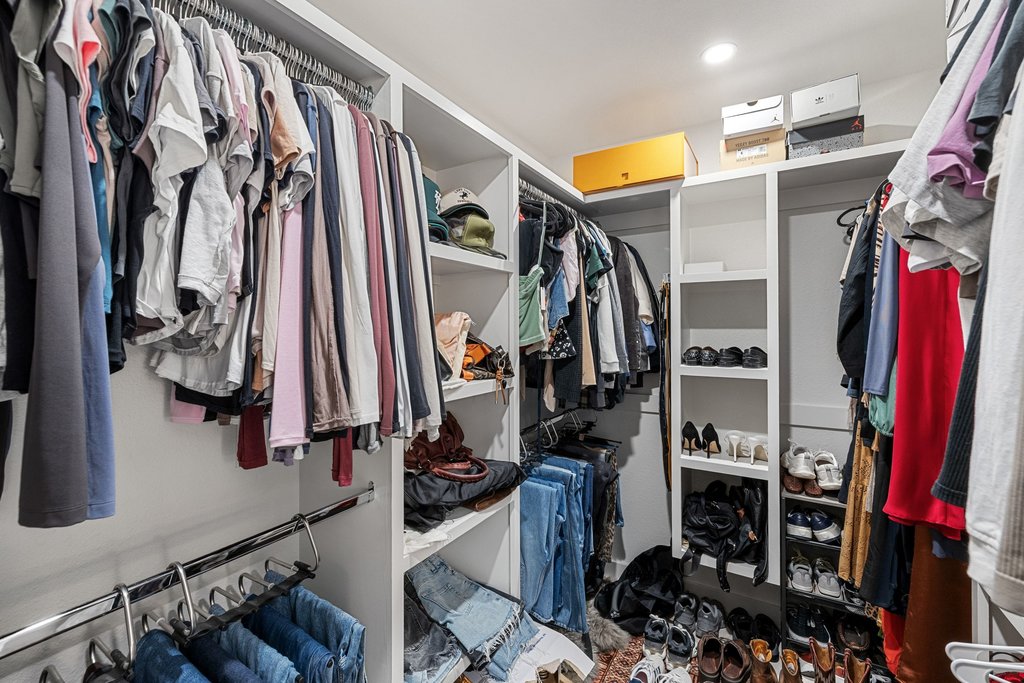 8202 Cache Drive Austin, TX 78749 - Photo 20 of 39 a view of walk in closet with clothes and shoes