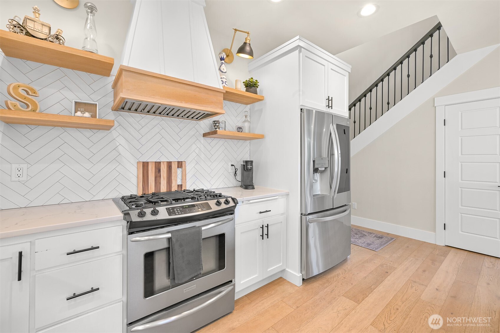 109 West 2nd Street Nooksack, WA 98276 - Photo 6 of 36 a kitchen with stainless steel appliances granite countertop a stove and a refrigerator