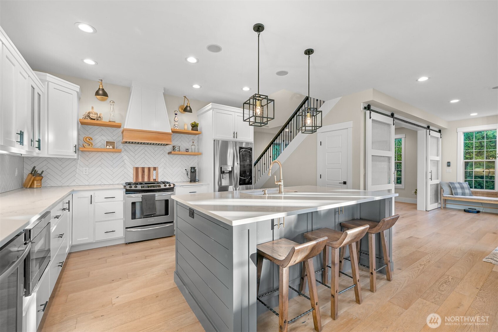109 West 2nd Street Nooksack, WA 98276 - Photo 7 of 36 a kitchen with stainless steel appliances kitchen island a large island in the center
