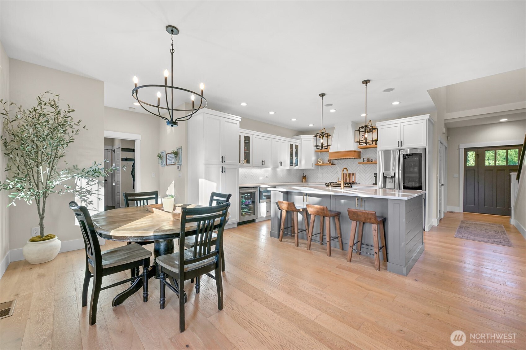 109 West 2nd Street Nooksack, WA 98276 - Photo 8 of 36 a view of a dining room and livingroom with furniture wooden floor a chandelier