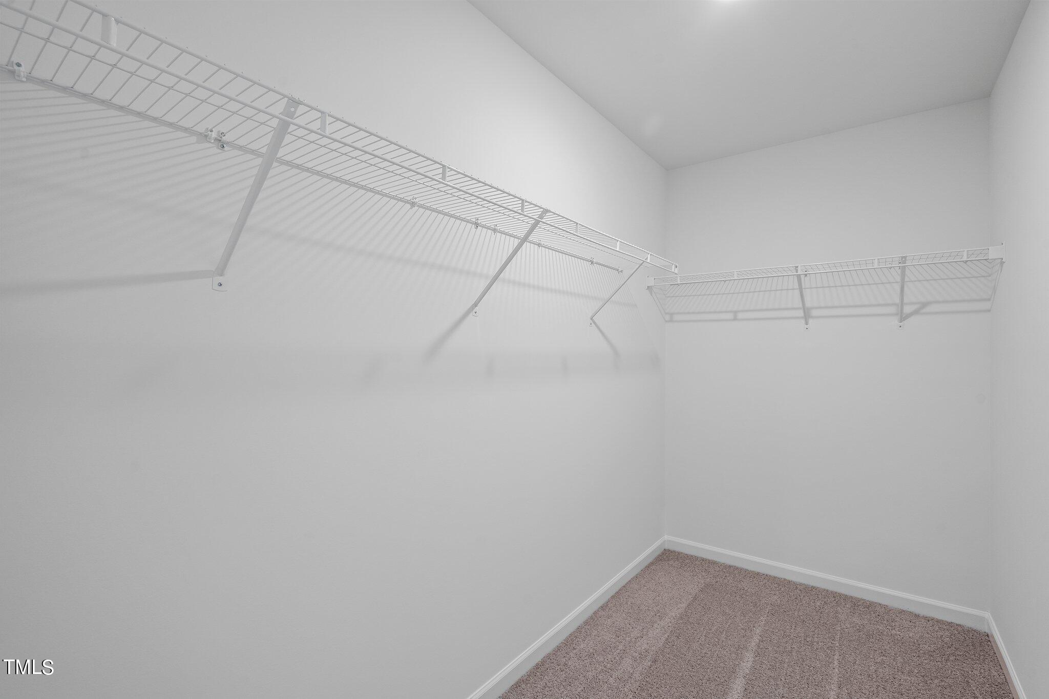 326 Spaight Acrs Way Wake Forest, NC 27587 - Photo 13 of 39 a view of a room with racks on the wall