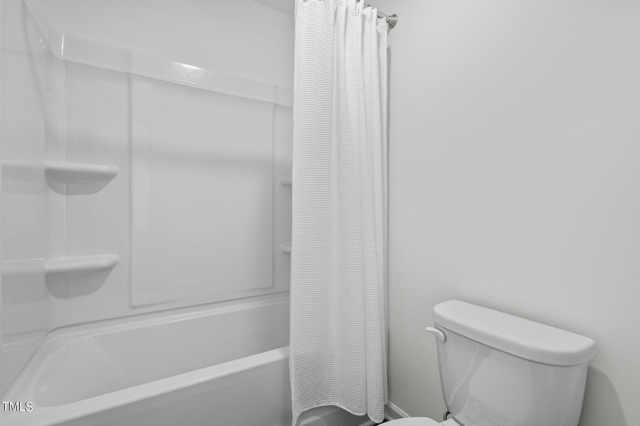 326 Spaight Acrs Way Wake Forest, NC 27587 - Photo 16 of 39 a bathroom with a shower and a toilet