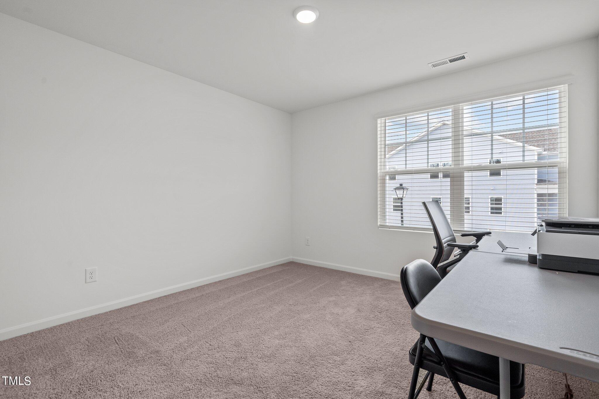 326 Spaight Acrs Way Wake Forest, NC 27587 - Photo 19 of 39 a view of a workspace with furniture and a window