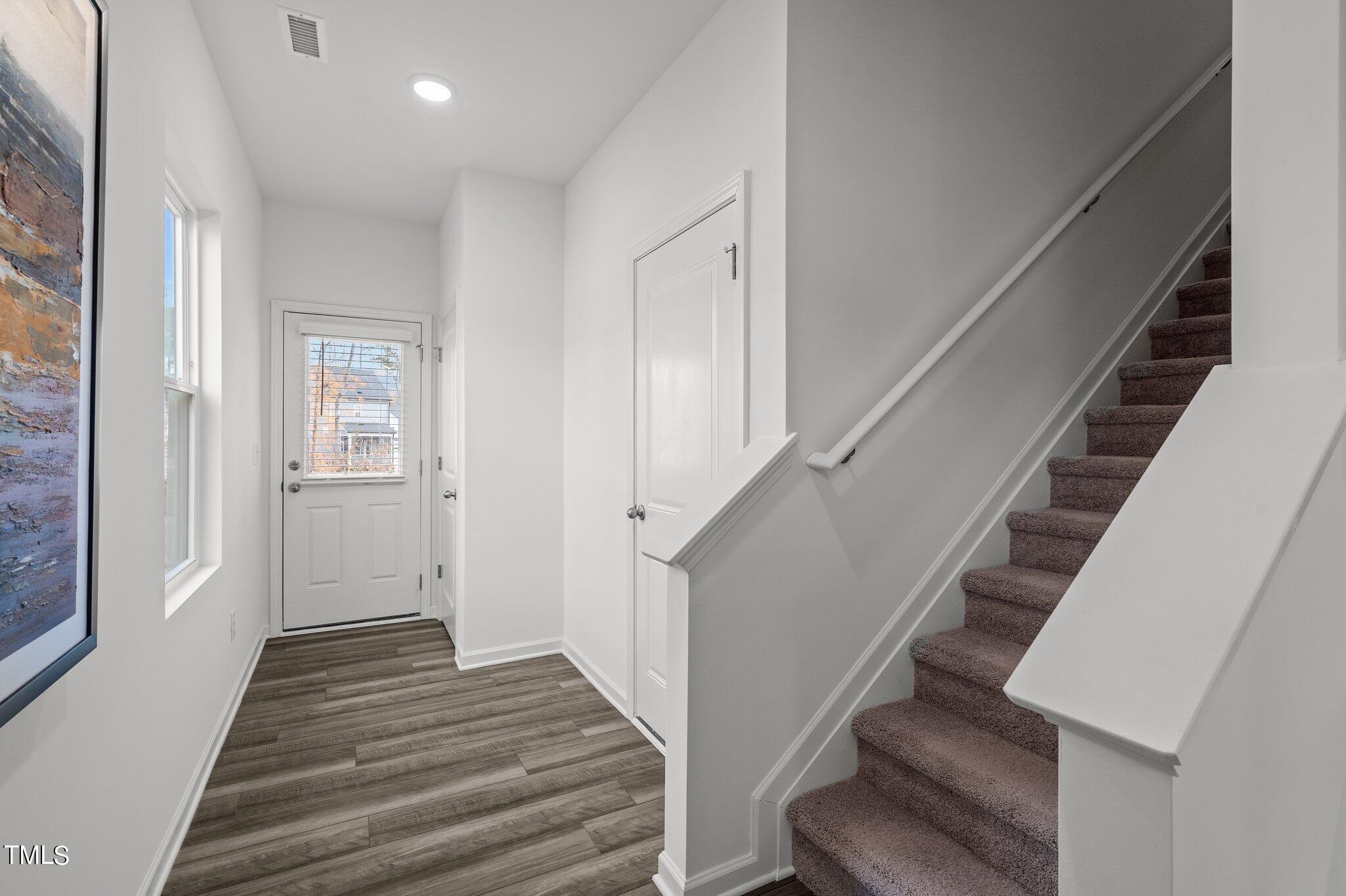 326 Spaight Acrs Way Wake Forest, NC 27587 - Photo 2 of 39 a view of a hallway with wooden floor and entryway