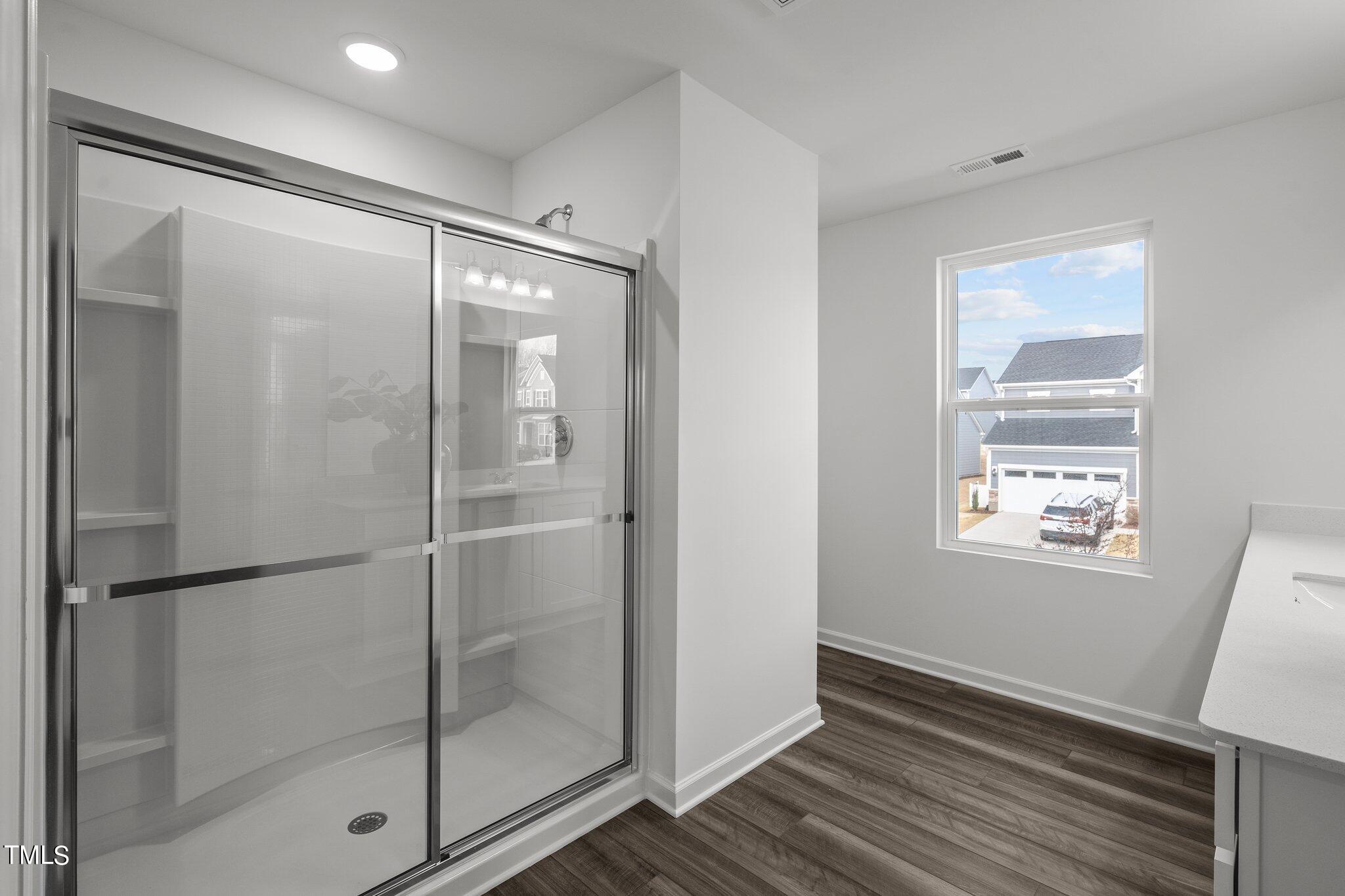 326 Spaight Acrs Way Wake Forest, NC 27587 - Photo 22 of 39 a bathroom with a glass shower door