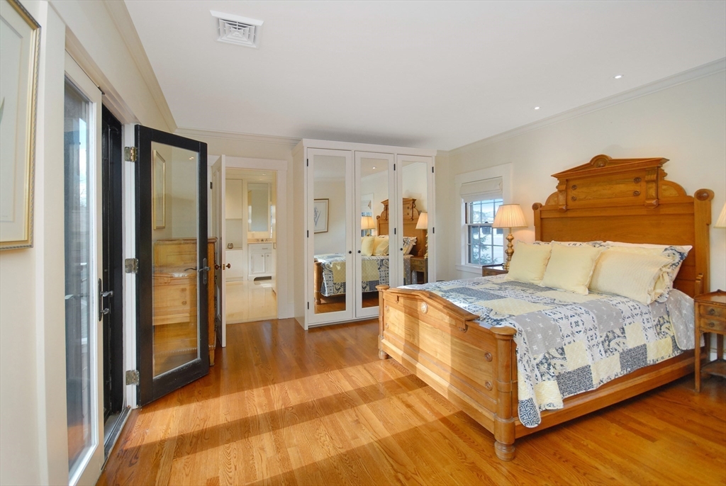 46 Sudbury Road Concord, MA 01742 - Photo 21 of 41 a bedroom with a bed and wooden floor