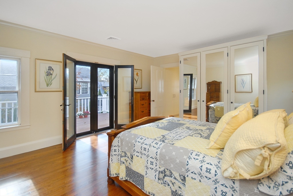 46 Sudbury Road Concord, MA 01742 - Photo 22 of 41 a bedroom with a bed and wooden floor