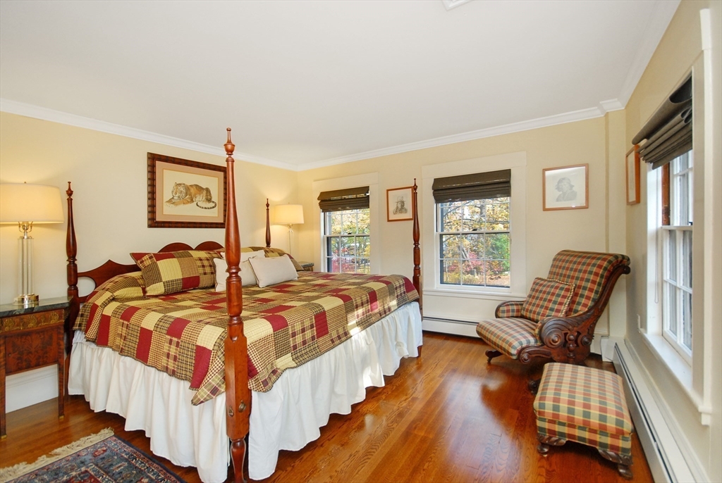 46 Sudbury Road Concord, MA 01742 - Photo 30 of 41 a bedroom with a bed and wooden floor