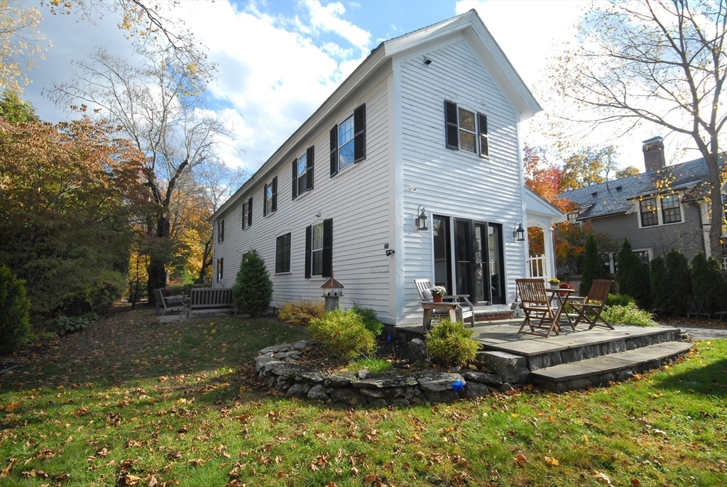46 Sudbury Road Concord, MA 01742 - Photo 38 of 41 a front view of a house with a yard table and chairs