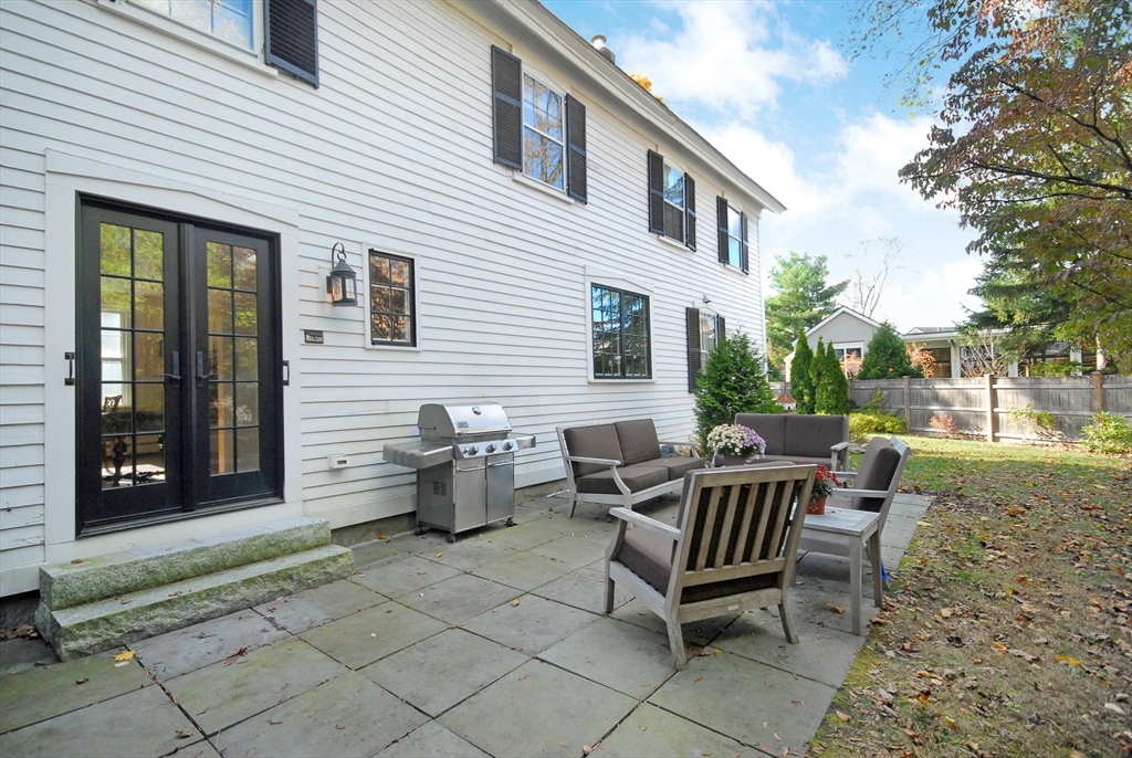 46 Sudbury Road Concord, MA 01742 - Photo 39 of 41 a view of a patio with a table and chairs