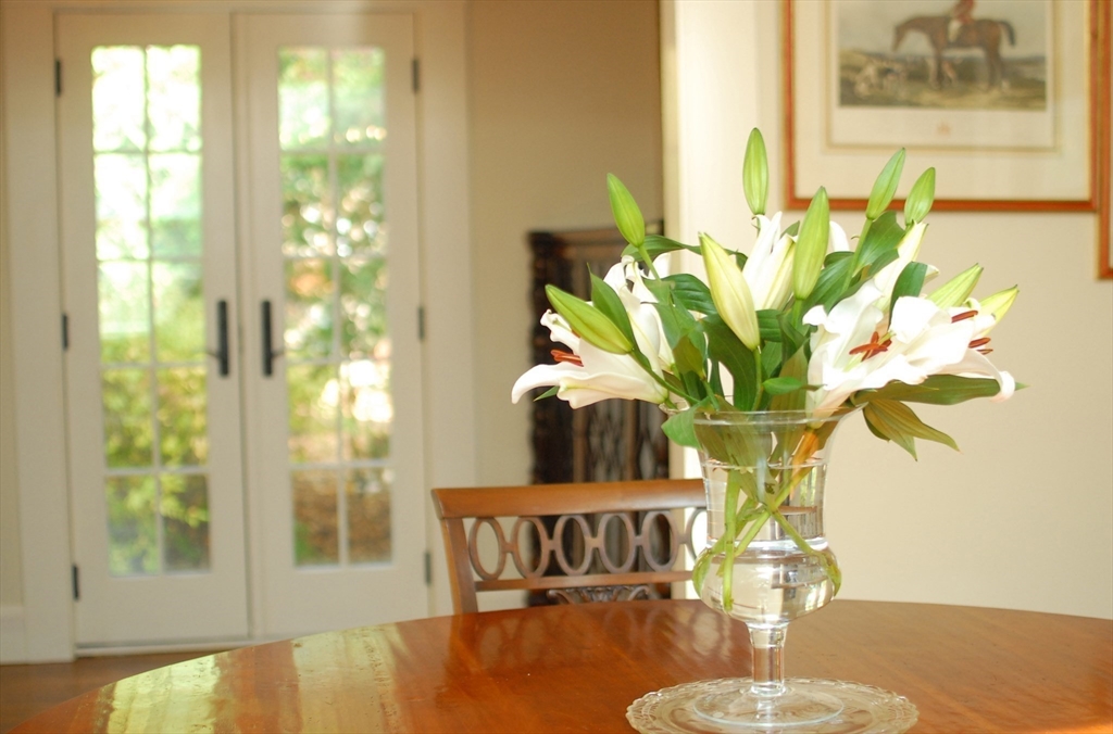46 Sudbury Road Concord, MA 01742 - Photo 9 of 41 a vase of flowers sitting on a table with window