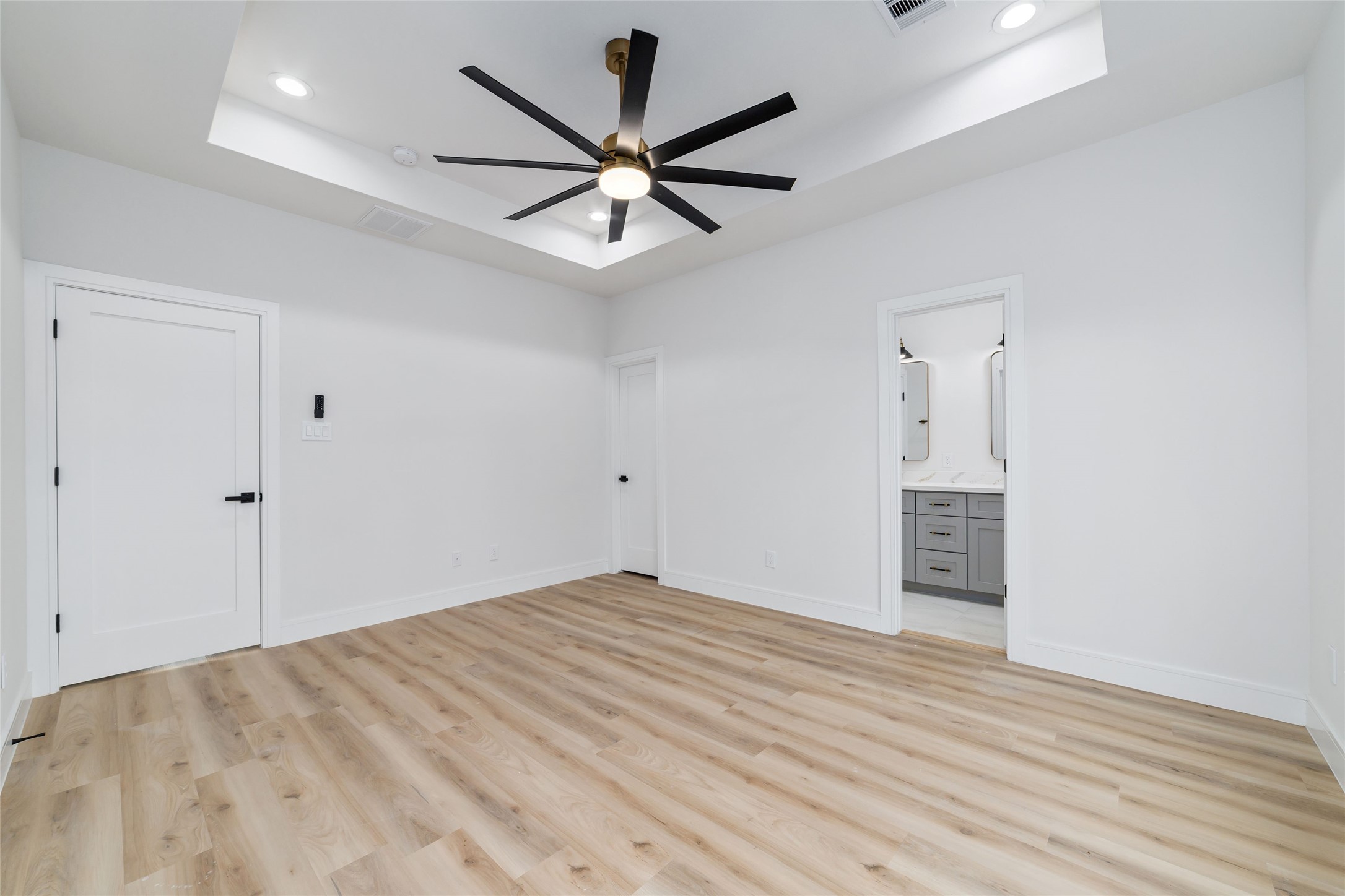 6717 England Street Houston, TX 77021 - Photo 13 of 25 an empty room with wooden floor and ceiling fan