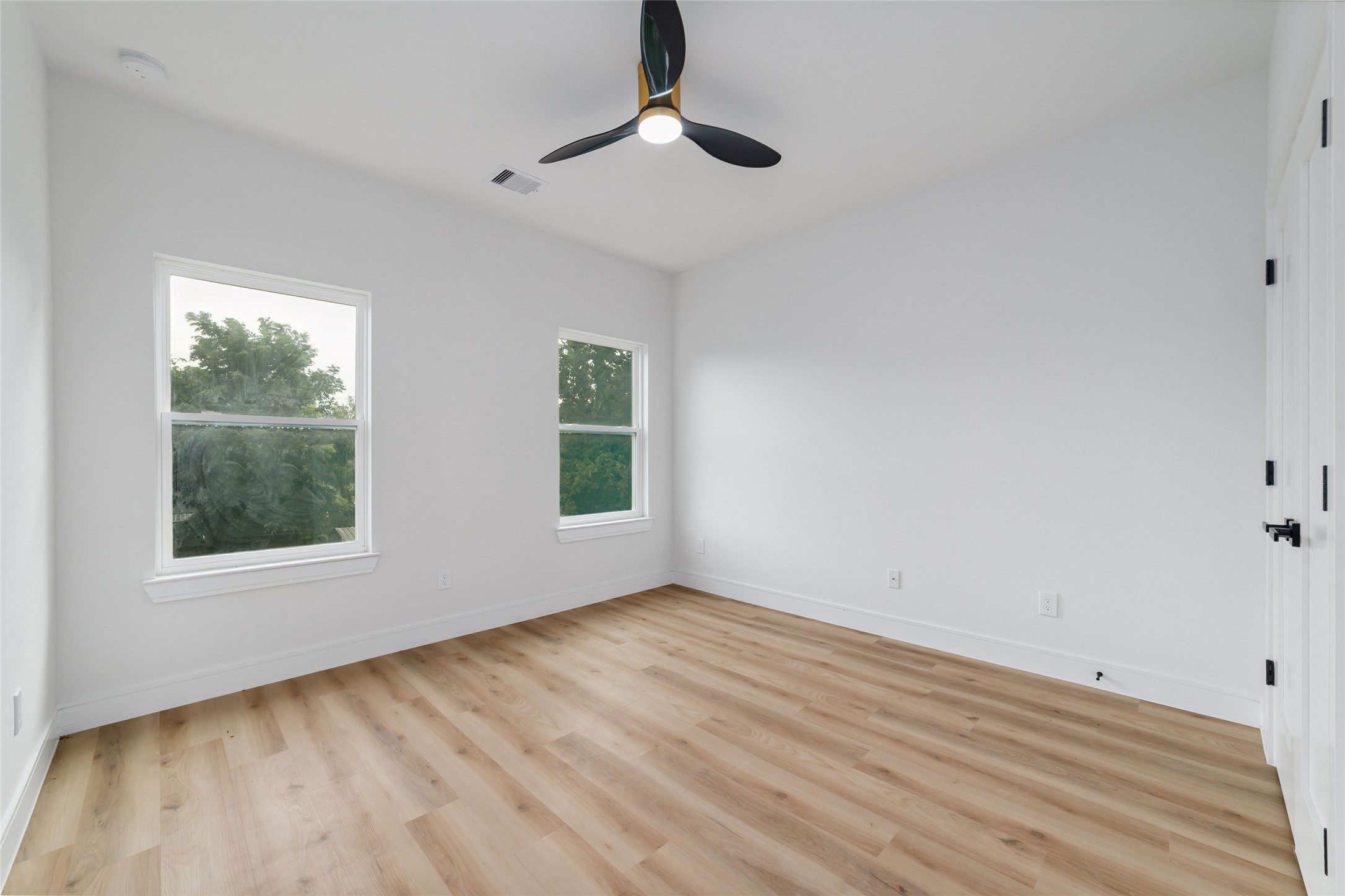 6717 England Street Houston, TX 77021 - Photo 16 of 25 wooden floor in an empty room with a window