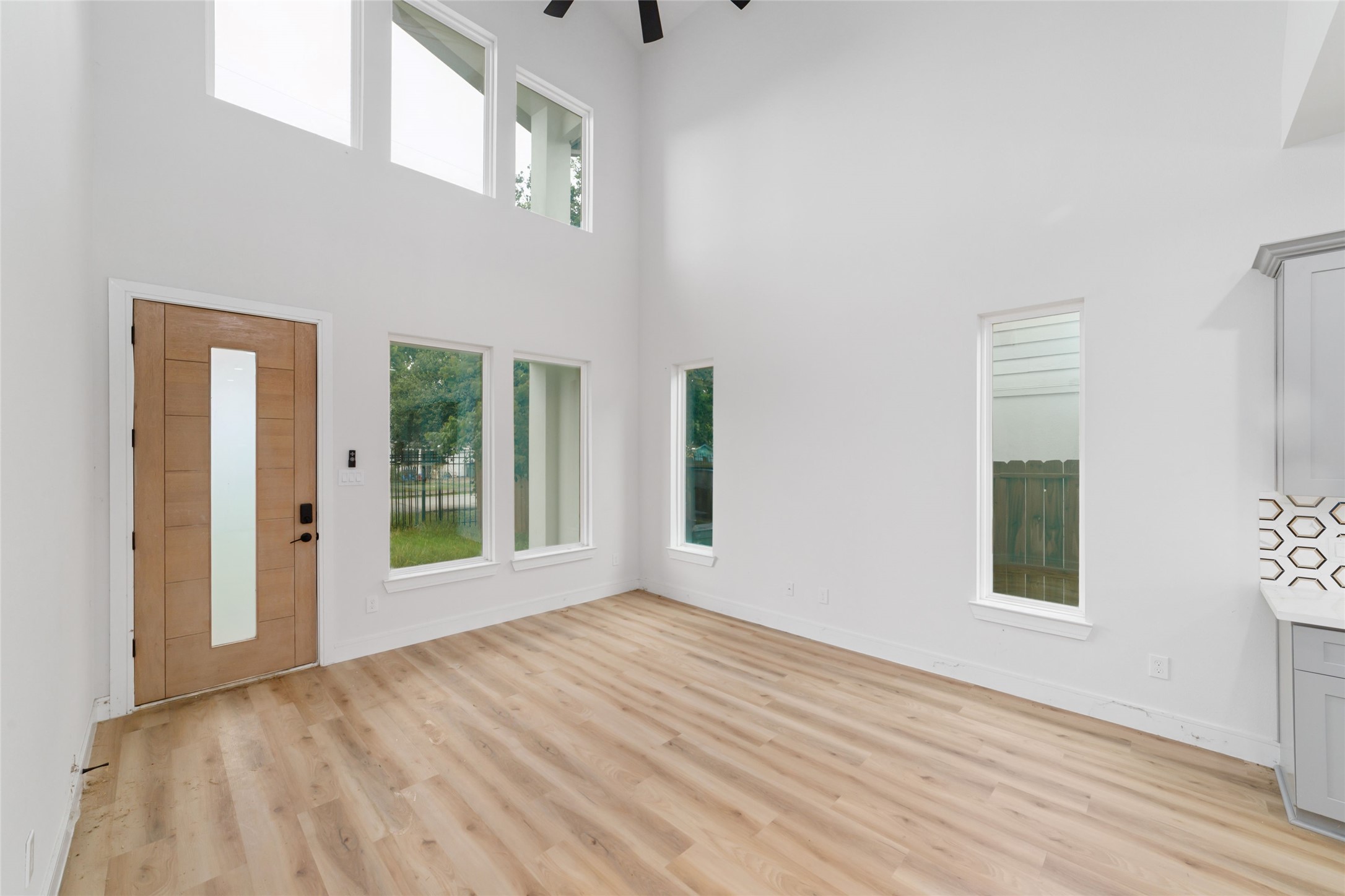 6717 England Street Houston, TX 77021 - Photo 21 of 25 a view of an empty room with wooden floor and a window