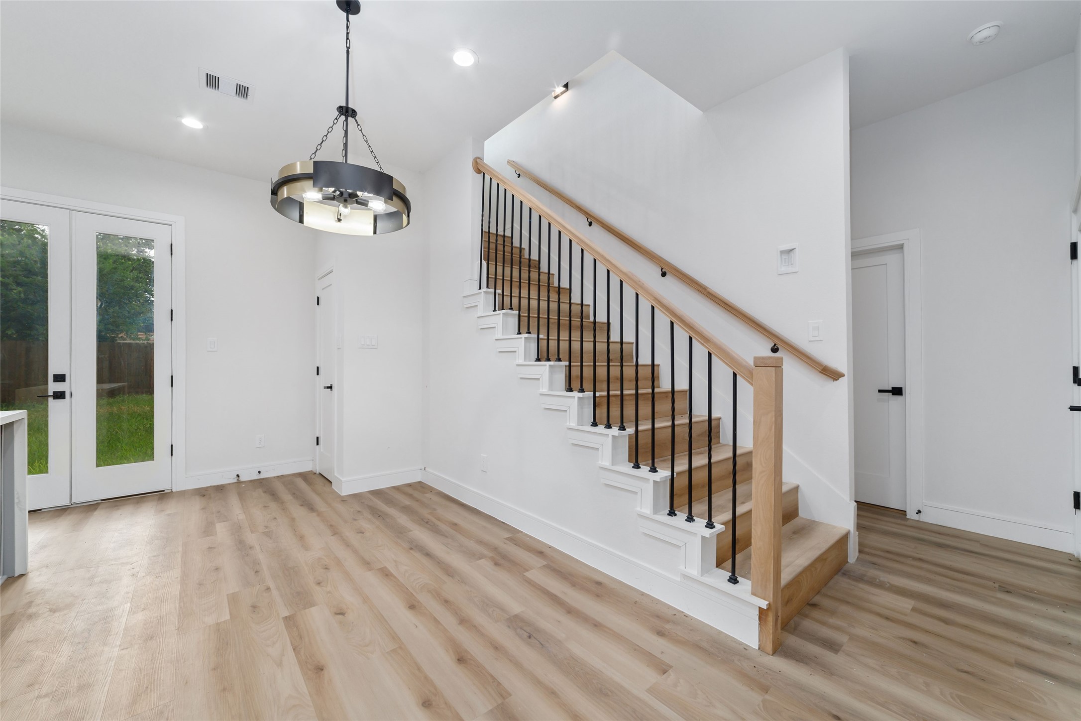 6717 England Street Houston, TX 77021 - Photo 9 of 25 a view of a room with wooden floor and stairs