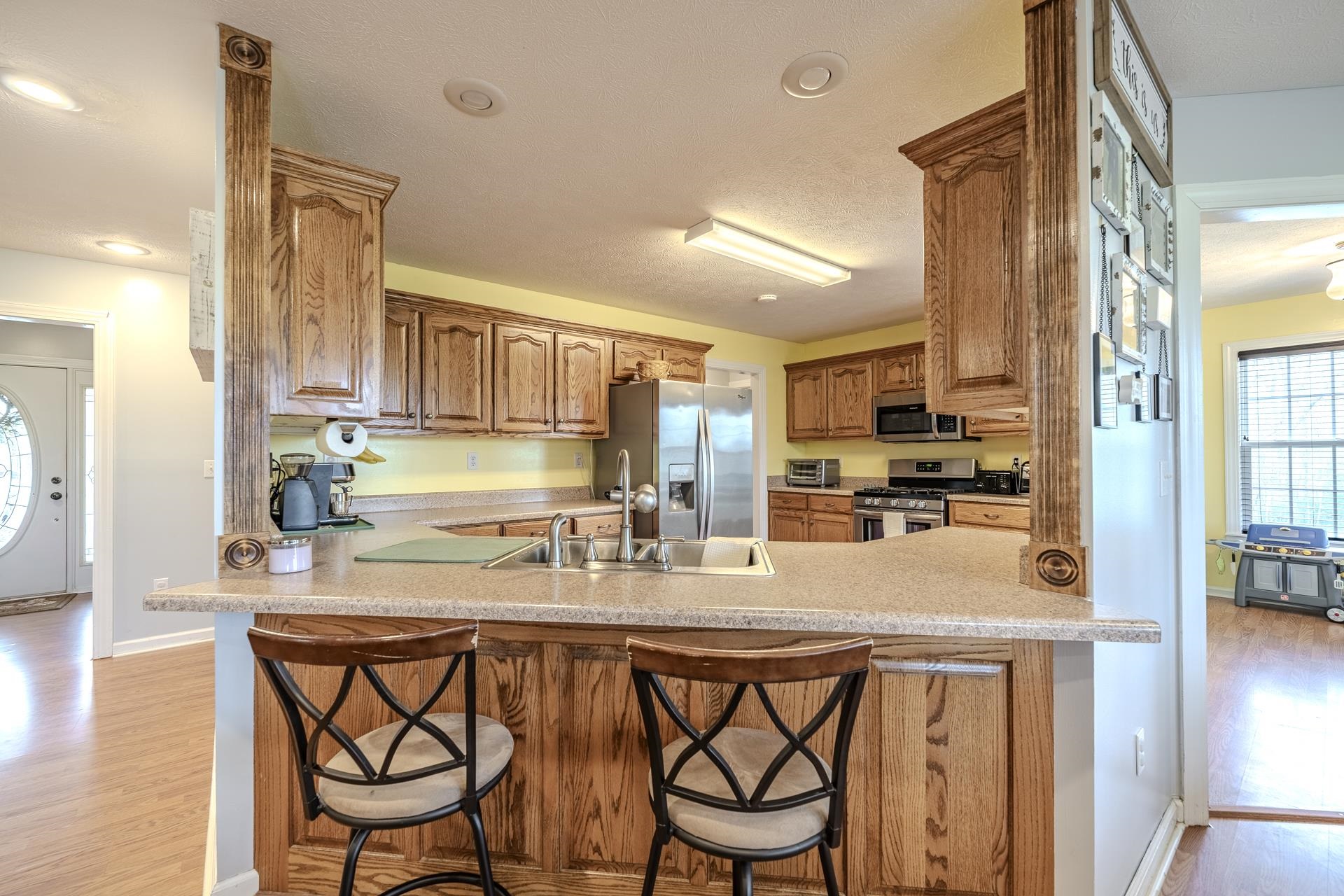 270 2 Boys Road Savannah, TN 38372 - Photo 12 of 35 Kitchen featuring plenty of natural light, a peninsula, and wood finish cabinetry