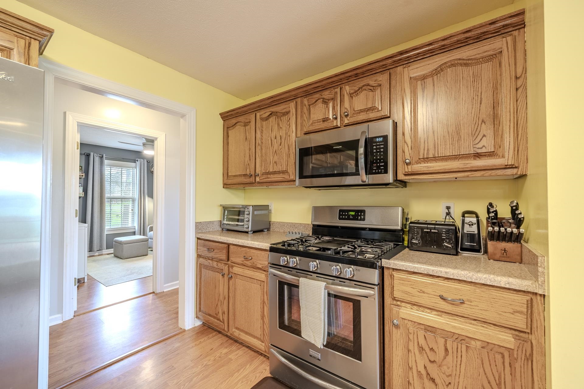 270 2 Boys Road Savannah, TN 38372 - Photo 13 of 35 Kitchen featuring stainless steel appliances, light countertops, and light wood-style flooring