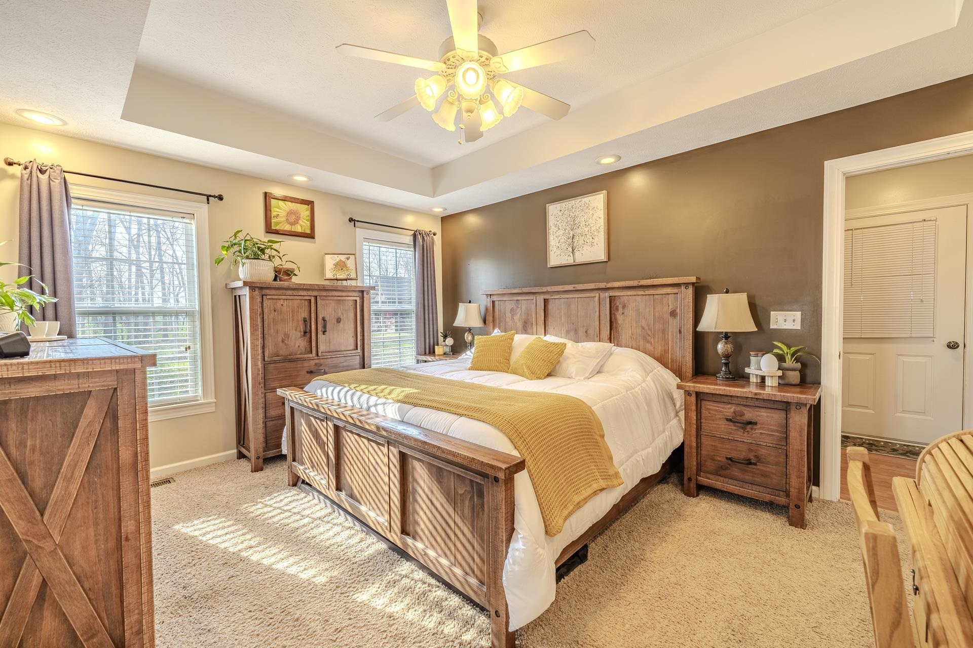 270 2 Boys Road Savannah, TN 38372 - Photo 16 of 35 Bedroom featuring a tray ceiling, light colored carpet, a ceiling fan, recessed lighting, and multiple windows