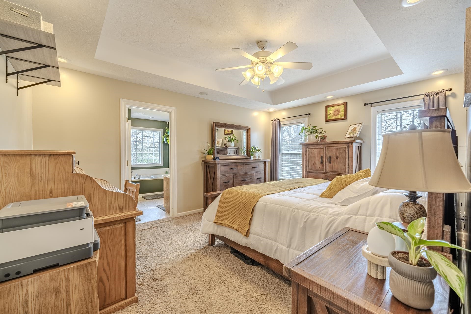 270 2 Boys Road Savannah, TN 38372 - Photo 17 of 35 Bedroom featuring recessed lighting, a tray ceiling, light colored carpet, multiple windows, and ceiling fan