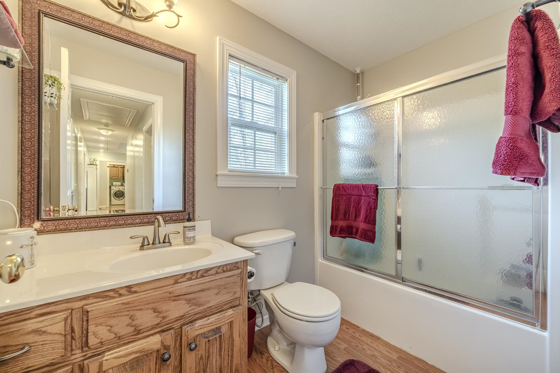 270 2 Boys Road Savannah, TN 38372 - Photo 25 of 35 Bathroom with vanity, combined bath / shower with glass door, and light wood-style floors