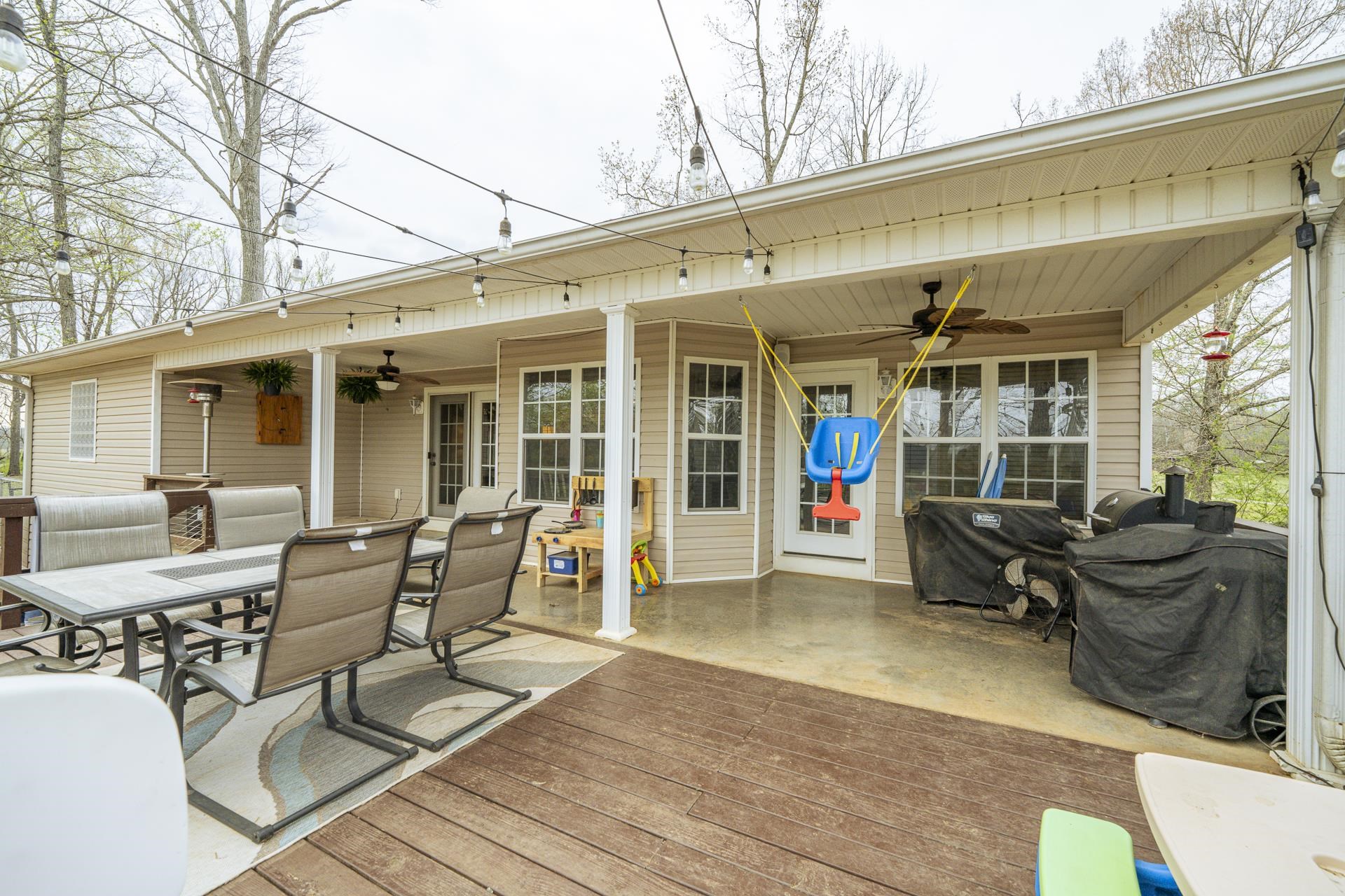 270 2 Boys Road Savannah, TN 38372 - Photo 27 of 35 Wooden terrace with ceiling fan, outdoor dining area, and a grill