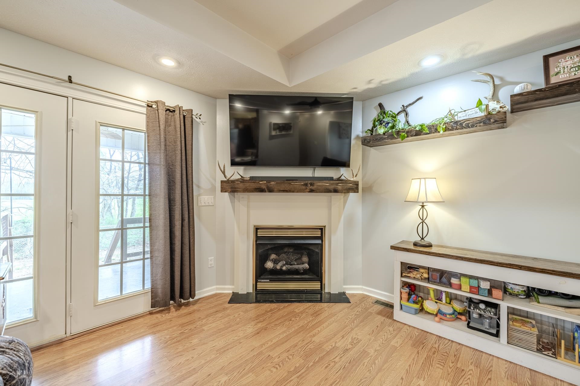 270 2 Boys Road Savannah, TN 38372 - Photo 8 of 35 Living area with light wood-style floors, recessed lighting, and a fireplace with flush hearth